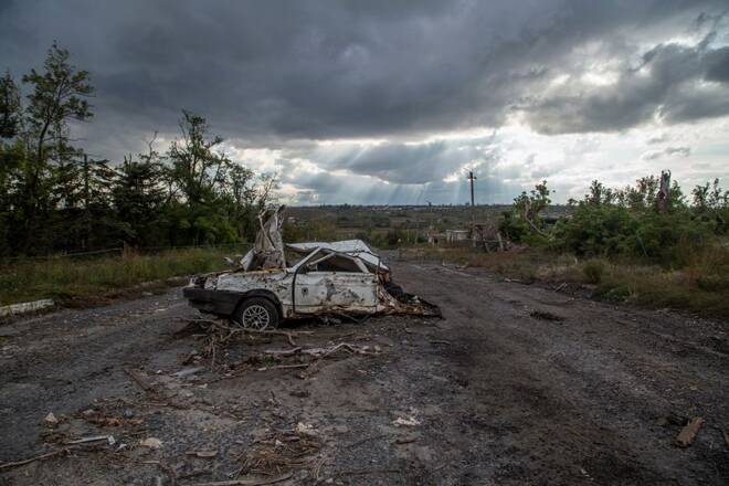 Destroyed civil car is seen on a road near the village of Velyka Komyshuvakha