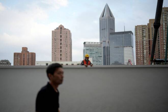 A construction worker looks over the wall, following the coronavirus disease (COVID-19) outbreak, in Shanghai
