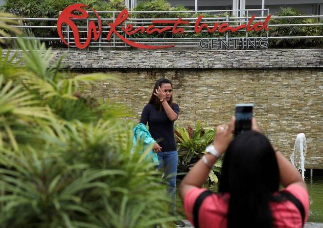 Visitors take picture with the signage of Genting Malaysia’s Resort sWorld in Genting Highlands