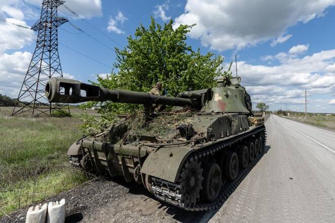 Ukrainian soldiers stand on top of a tank, amid Russia's invasion of Ukraine, in the frontline city of Lyman