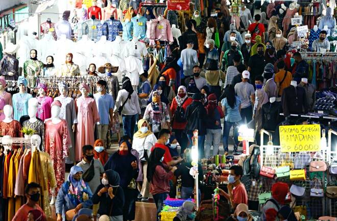 People wearing protective face masks shopping in Tanah Abang textile market ahead of Eid al-Fitr festival amid the coronavirus outbreak in Jakarta