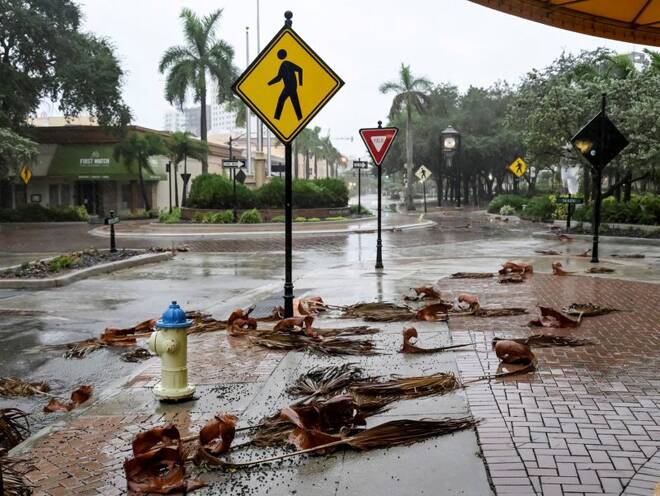 Downed palm fronds collect on an empty downtown intersection as Hurricane Ian approaches Florida’s Gulf Coast