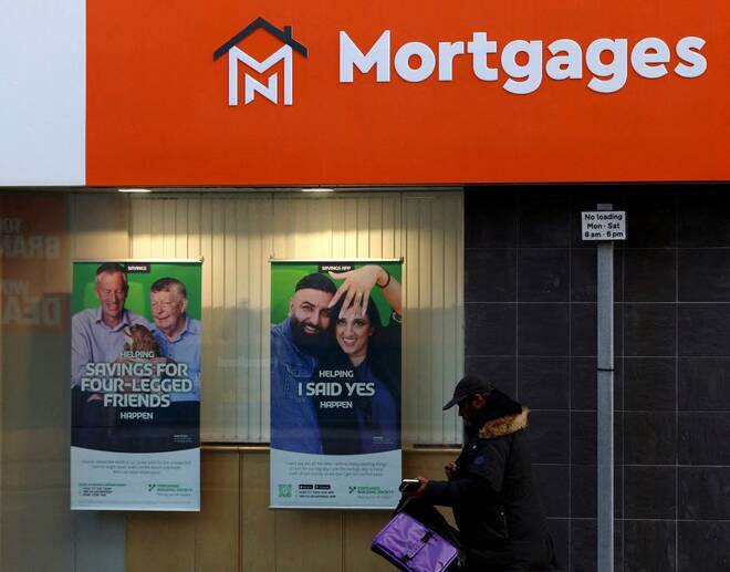 A shopper walk past a mortgage advertisement displayed in a window in Sunderland, Britain.