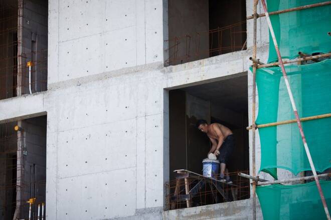 A man works at a construction site of apartment buildings in Beijing