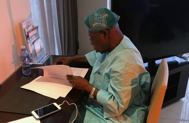 FILE PHOTO - Former Nigerian president and chairman of the West Africa Commission on Drugs, Olusegun Obasanjo, looks at documents during an interview with Reuters in Dakar