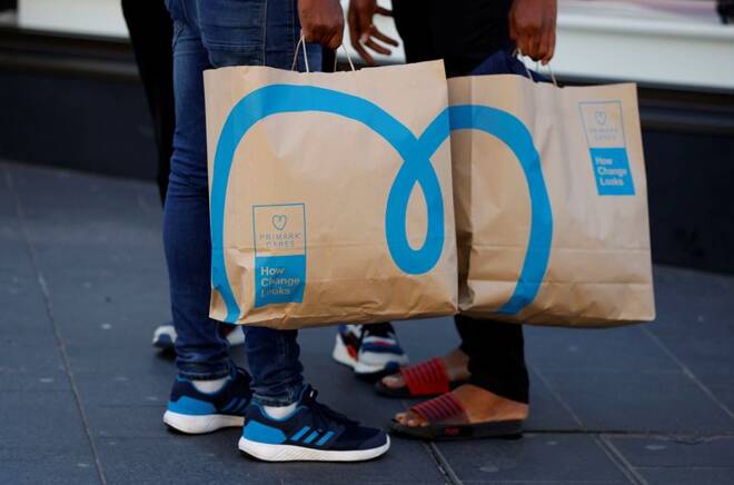 Shoppers holding newly environmentally themed bags stand outside a Primark store in Liverpool