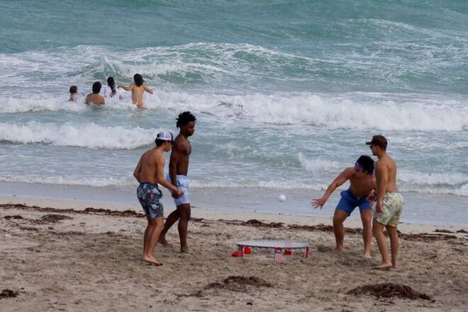 Beachgoers are shown as tropical storm Nicole approaches the state in Miami Beach