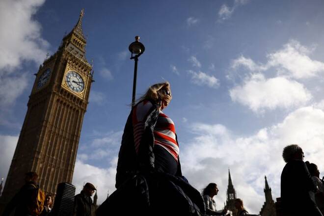 People walk in front of the Elizabeth Tower, more commonly known as Big Ben in London