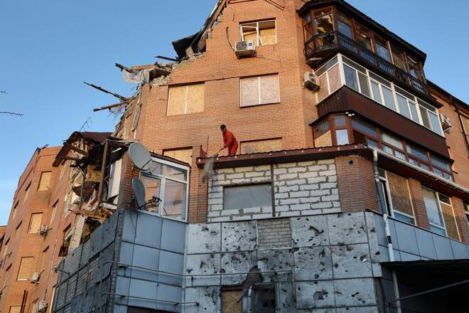 A man cleans rubble at a damaged residential building, as Russia's attack on Ukraine continues, in Mykolaiv
