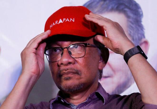 Malaysia's opposition leader Anwar Ibrahim adjusts his cap during his campaign rally of Malaysia's general election in Ulu Klang