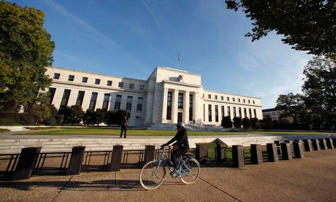 Cyclist passes the Federal Reseve in Washington