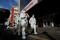Pandemic prevention workers in protective suits walk near an apartment compound that was placed under lockdown as outbreaks of the coronavirus disease (COVID-19) continue in Beijing