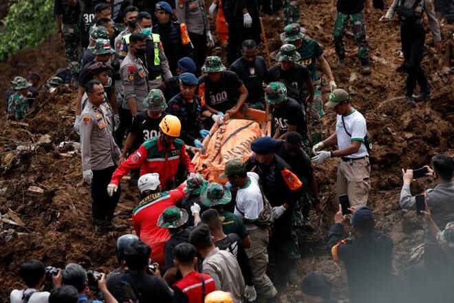 Indonesia rescue members carry a victims body from the site of a landslide caused by the earthquake in Cugenang