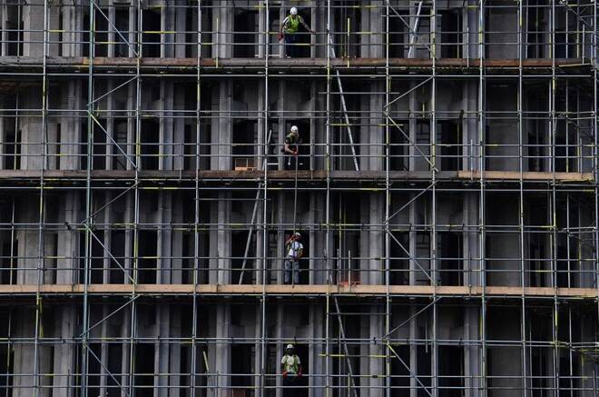 Scaffolders work on a construction site in London, Britain