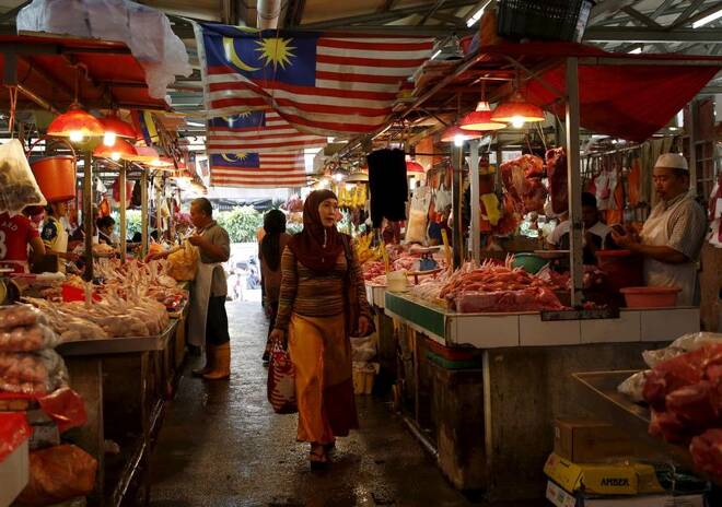 A woman shops in a wet market in Kuala Lumpur
