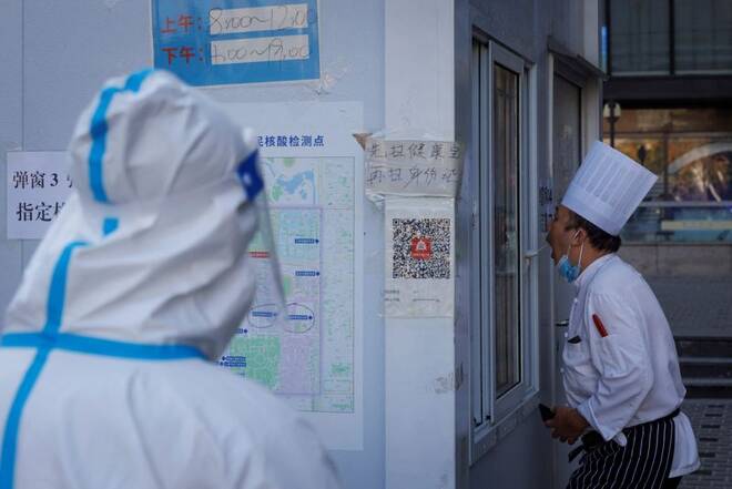 A chef gets a swab test at a testing booth as outbreaks of coronavirus disease (COVID-19) continue in Beijing