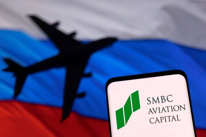 Illustration shows SMBC Aviation Capital logo displayed in front of the model of an airplane and a Russian flag