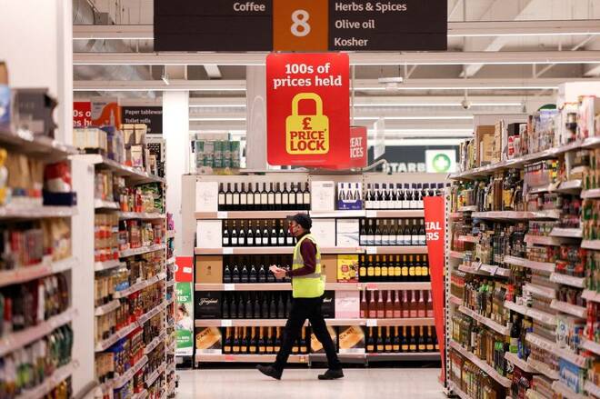 An employee walks inside a Sainsbury’s supermarket in Richmond, west London