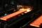 Red-hot steel plates pass through a press at the Tata steel plant in Ijmuiden