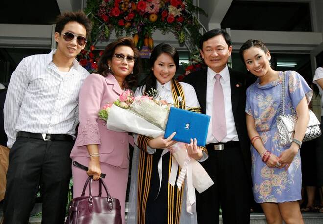 Ousted Thai PM Thaksin poses for a family photo on the graduation day of his daughter Paetongtarn at a Bangkok university