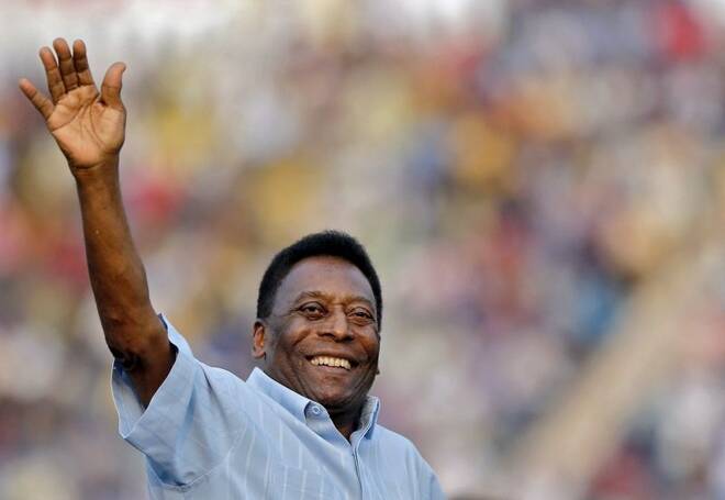 Legendary Brazilian soccer player Pele waves to the spectators before the start of the under-17 boys' final soccer match of the Subroto Cup tournament in New Delhi