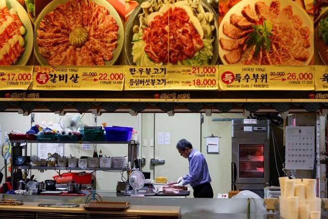 Lee Sang-jae, owner of a meat restaurant, cuts meat at a restaurant in Seoul