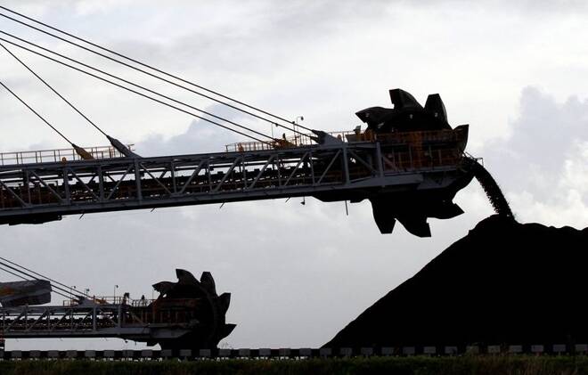 A stacker/reclaimer places coal in stockpiles at the coal port in Newcastle June 6, 2012