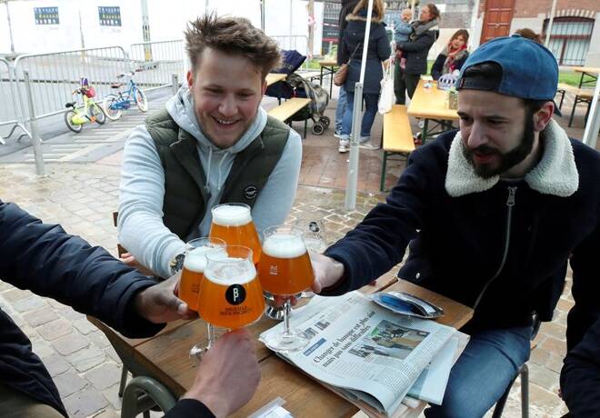 Customers enjoy a beer on the terrace at La Fourmiliere bar while Belgium reopens outdoor spaces