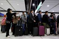 Travellers queue up at Hong Kong's Lok Ma Chau border checkpoint on the first day China reopens the border amid the COVID-19 pandemic in Hong Kong