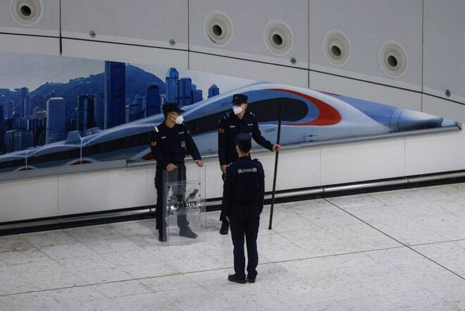 A Chinese police officer stands guard at in the mainland port area of West Kowloon High-Speed Train Station Terminus on the first day of the resumption of rail service to mainland China, during the coronavirus disease (COVID-19) pandemic in Hong Kong