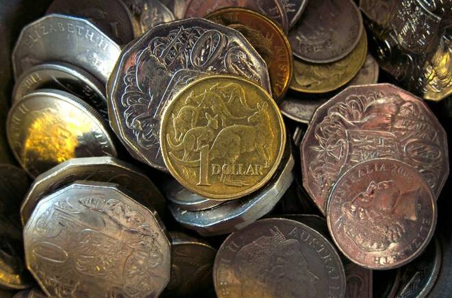 An Australian one dollar coin can be seen amongst various other Australian coins at a store in Sydney, Australia