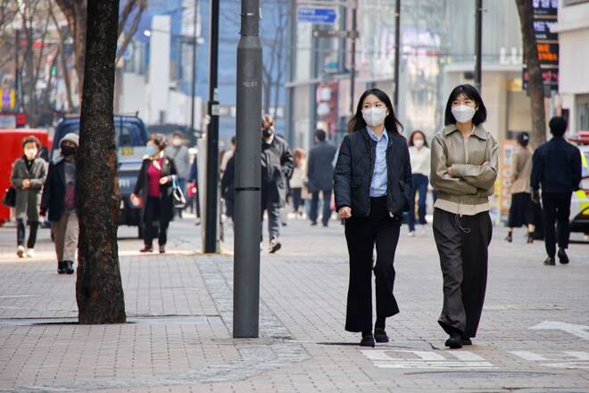 Women wearing masks walk in a shopping district amid the coronavirus disease (COVID-19) pandemic in Seoul