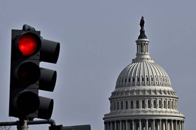 Red light traffic signal is seen with the dome of the U.S. Capitol building in the distance, in Washington