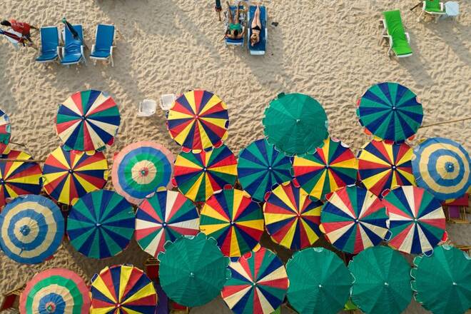 Colourful umbrellas are seen in a restaurant as tourists enjoy a beach in the island of Phuket in Thailand