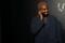 Rapper Kanye West talks on the phone before attending the Versace presentation in New York