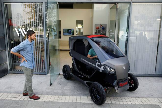 A mini electric car developed by City Transformer drives out of the company's offices during a demonstration for Reuters in Kfar Netter