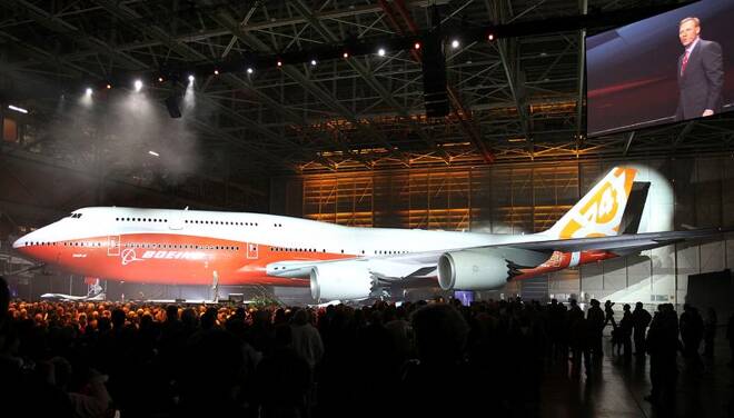 Boeing raises a curtain to unveil the 747-8 jumbo passenger jet to thousands of employees and guests at the company's Everett, Washington commercial airplane manufacturing facility