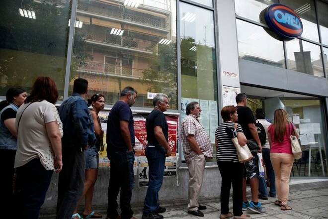 People wait outside a Greek Manpower Employment Organisation (OAED) office in a suburb of Athens