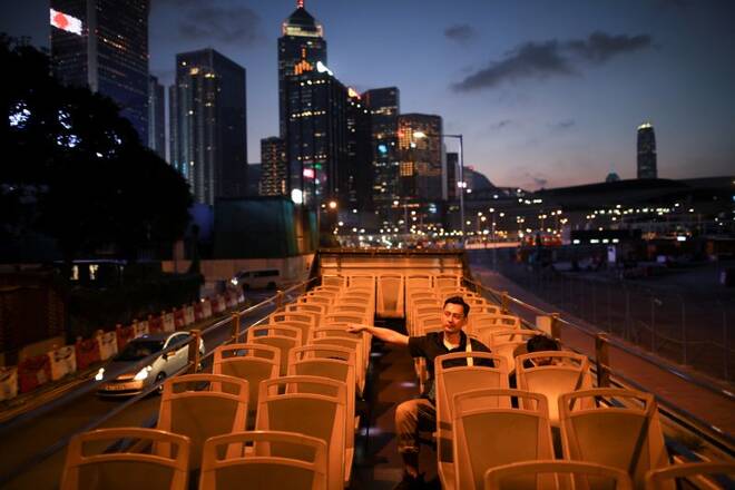 Tourists ride a tour bus in Hong Kong