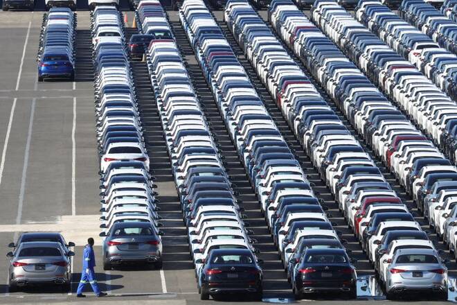 Worker inspects Mercedes-Benz cars at a port, in East London