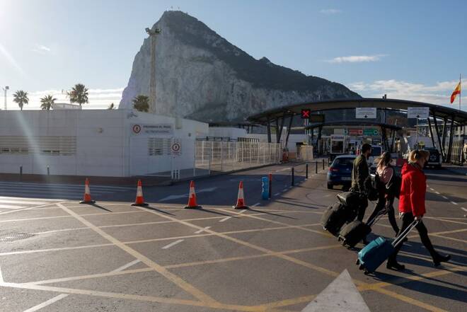 Tourists walk at the border between Spain and Gibraltar, in La Linea de la Concepcion