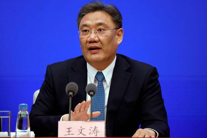 Chinese Commerce Minister Wang Wentao attends a State Council Information Office news conference in Beijing