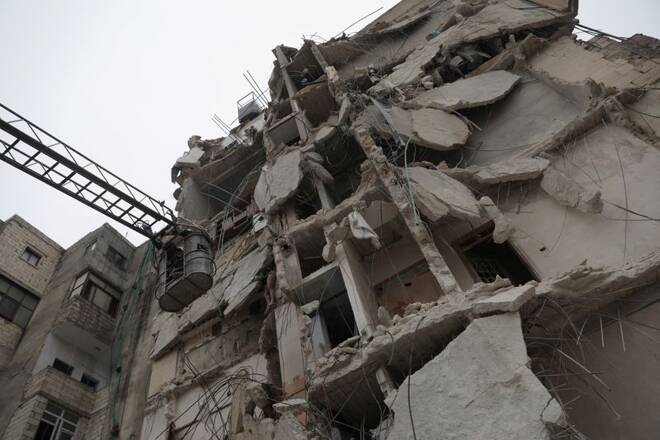 Rescuers work at the site of a collapsed building following an earthquake in rebel-held Idlib