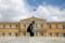 A man passes in front of the Greek parliament building in Athens