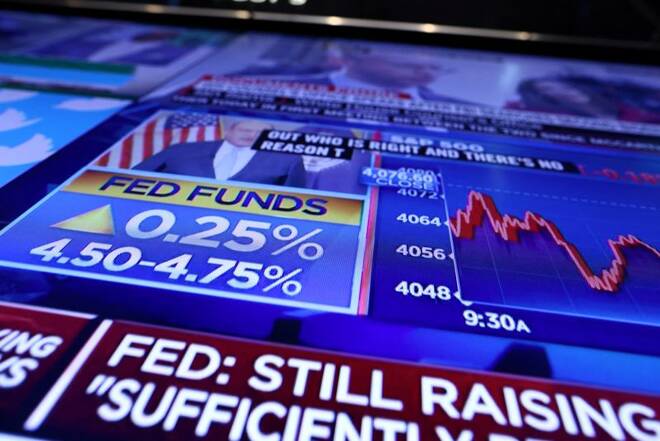 The Fed rate announcement is seen on a screen on the floor of the New York Stock Exchange (NYSE) in New York City