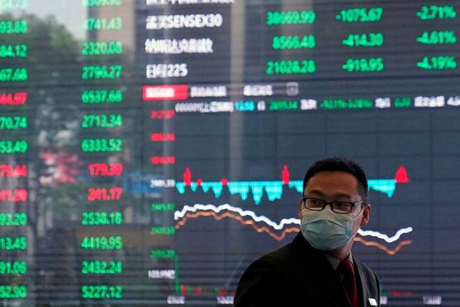 A man wearing a protective mask is seen inside the Shanghai Stock Exchange building