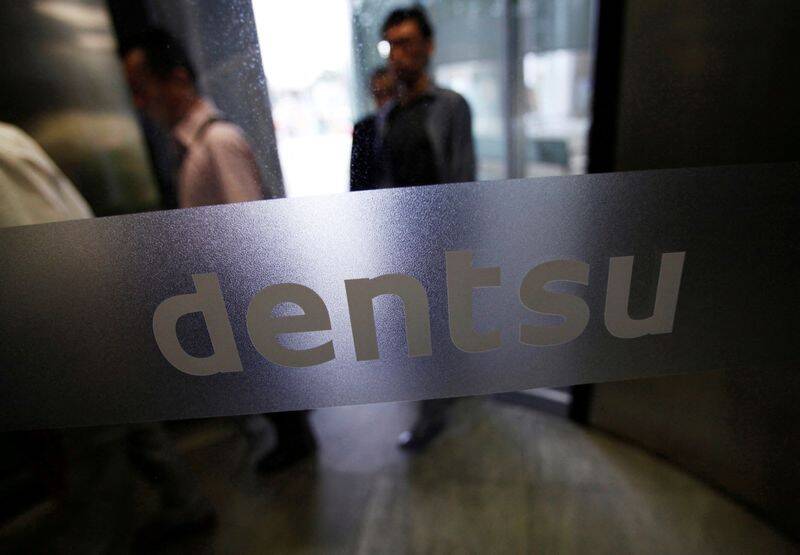 The logo of Dentsu Co. is seen at the entrance of the company headquarters in Tokyo