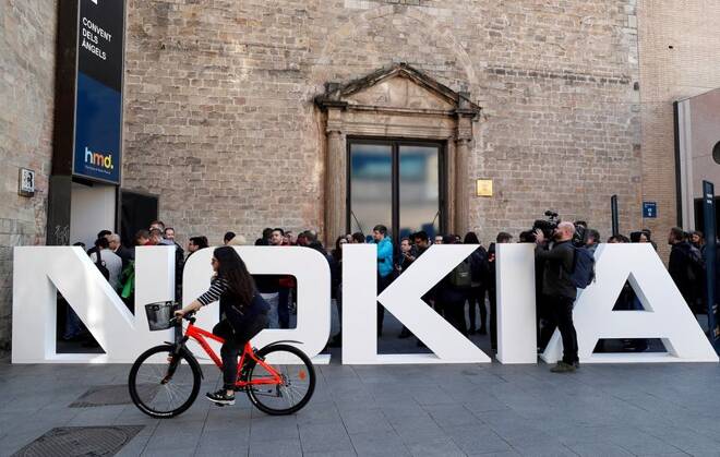 A cyclist rides past a Nokia logo during the Mobile World Congress in Barcelona