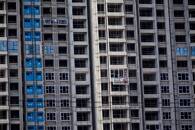 Workers install windows for residential buildings under construction, following the coronavirus disease (COVID-19) outbreak, in Shanghai