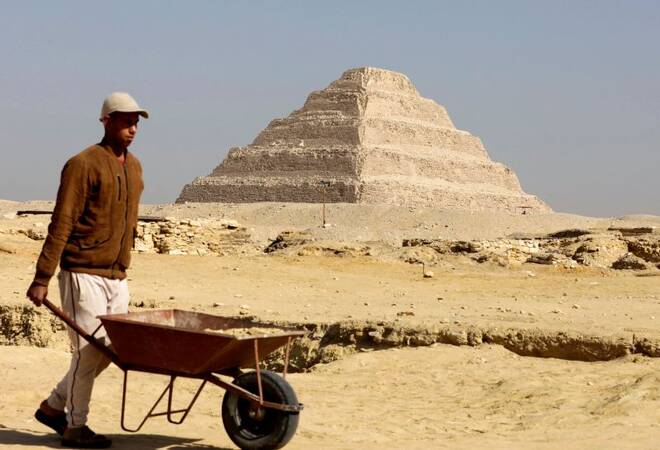 A worker walks in front of the Pyramid of Djoser after the announcement of 4,300-year-old sealed tombs discovered in Egypt's Saqqara necropolis, in Giza